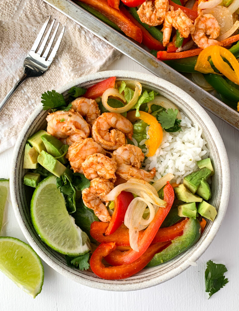 sheet pan shrimp fajitas in a burrito bowl